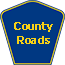 Blue sign with yellow trim representing County Highways